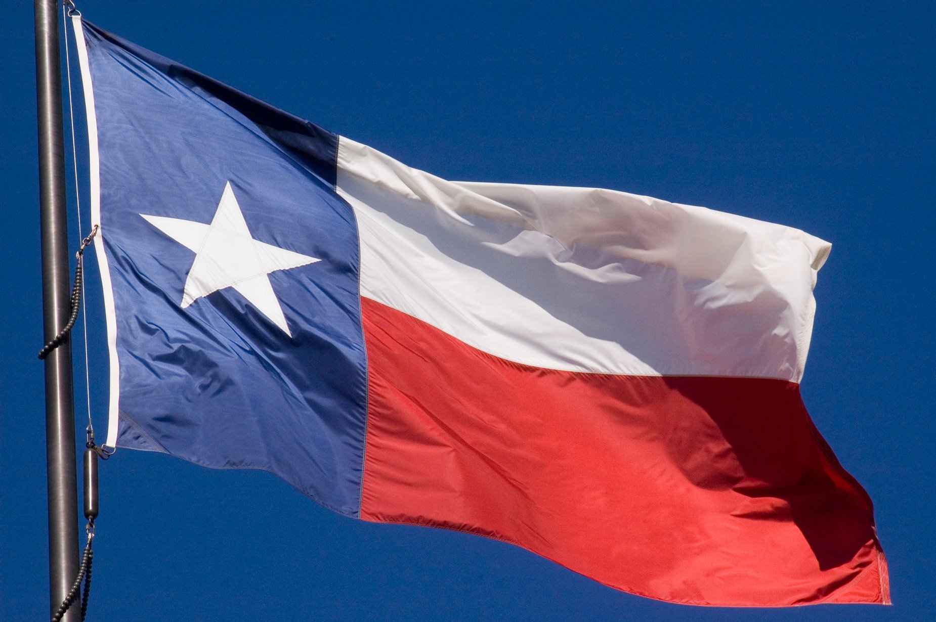 The state of Texas lone star flag flying proudly in the air